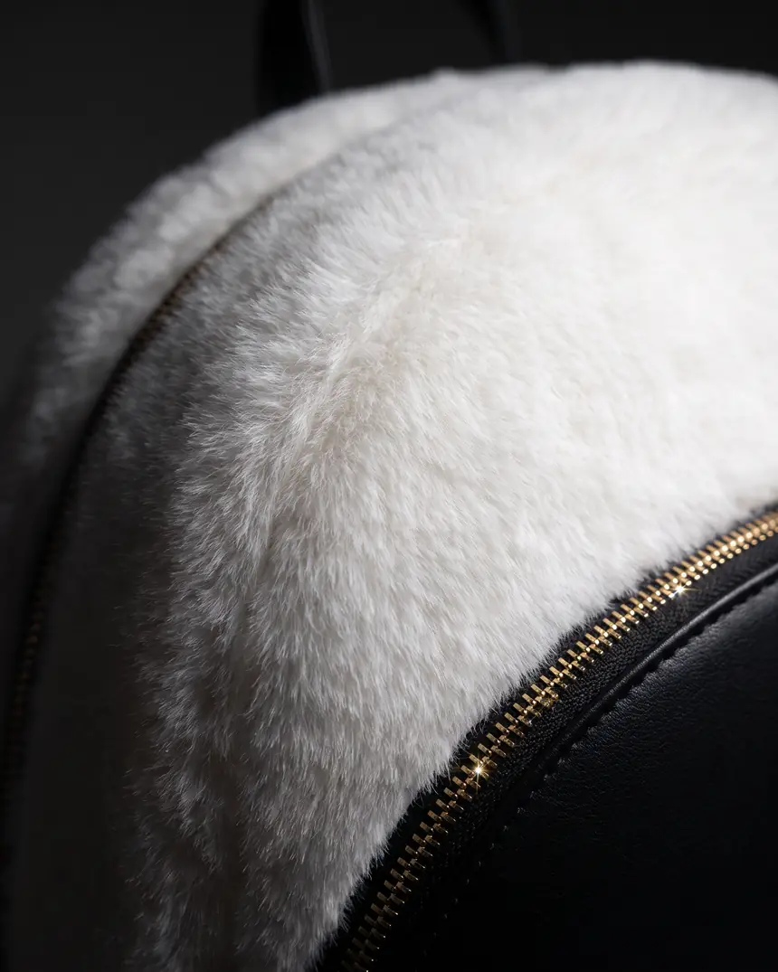 Macro of the short-pile plush coat meeting the gold zipper
